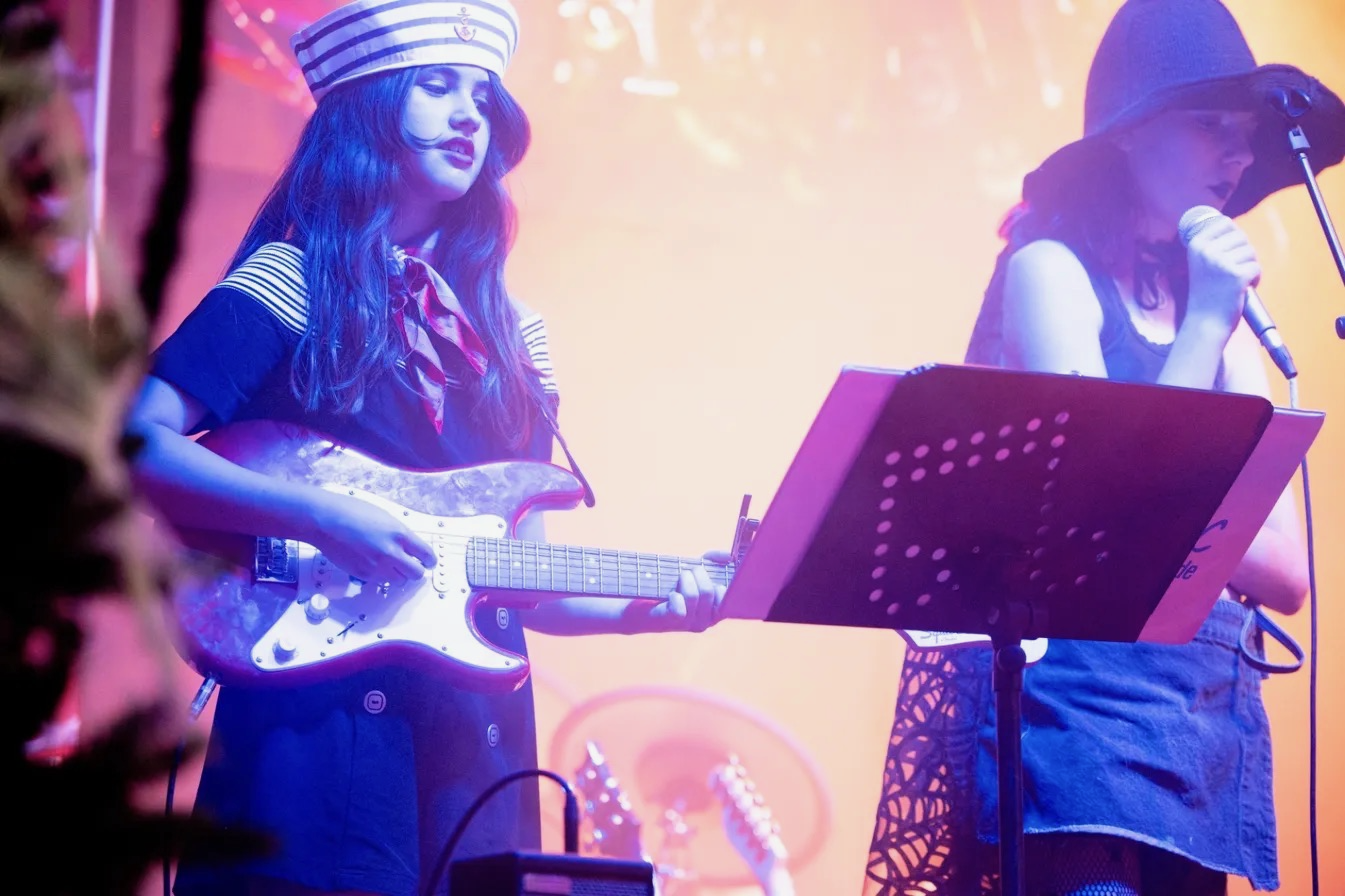 MOTW guitar students performing live on stage