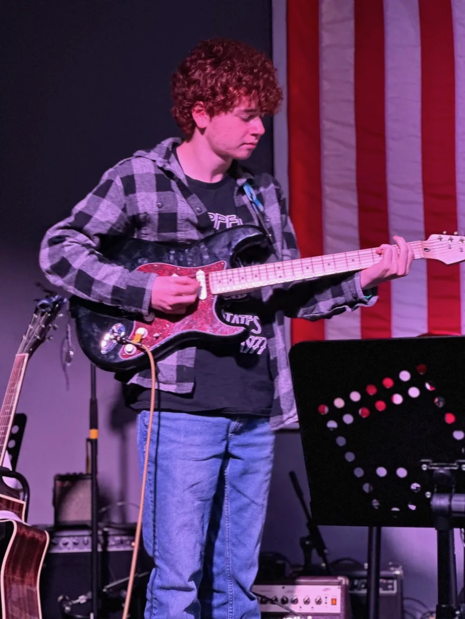 Student performing guitar at movie music showcase