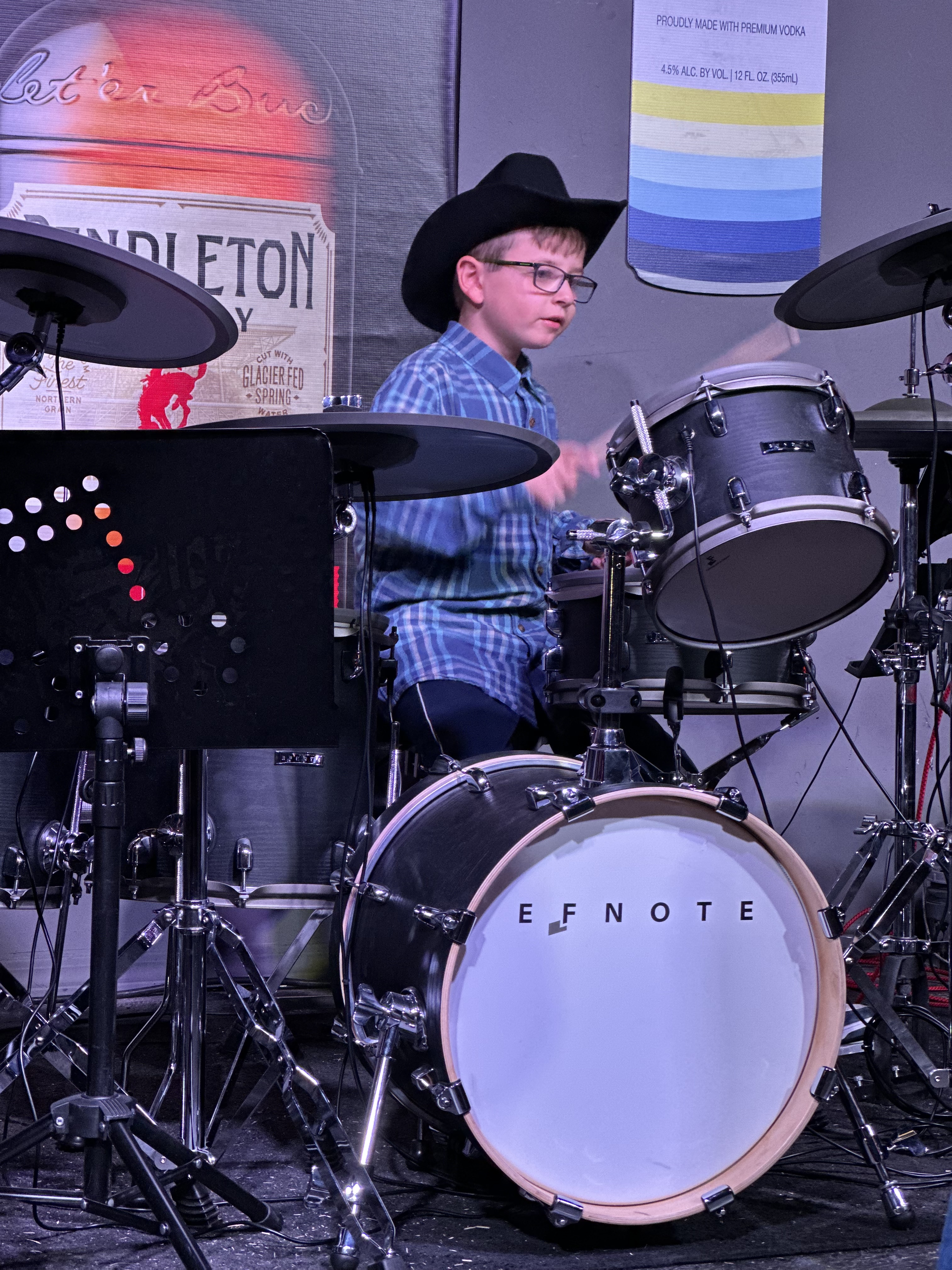 Young drum student performing live on stage at Southern Rock concert
